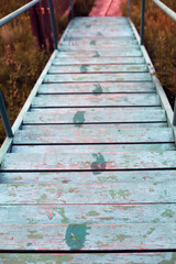 Obraz premium an old blue staircase that leads down to the shore.