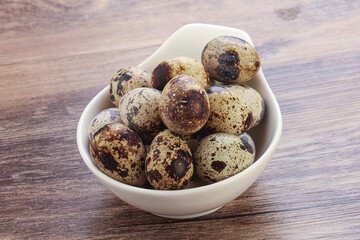 Raw quail eggs heap in the bowl