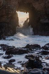 A sunset sky peeping thought the keyhole arch at Pfeiffer Beach, near Big Sur California.
