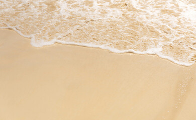 Soft oceans wave with foam and clear white sand. Tropical beach by the ocean  