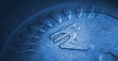 Translation: rupee. Fragment of Indian 10 rupee coin with the sign of the national currency close-up. Blue tinted illustration with vignettig. Economy and finance of India. Horizontal stories. Macro