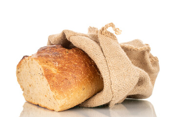 One half of buckwheat fragrant bread with a jute bag, macro, isolated on a white background.