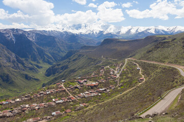 Fototapeta na wymiar View of snow-capped mountain peaks from the Armenian village Halidzor near the cable car 