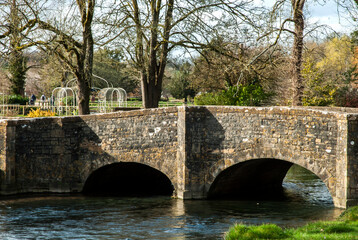Fototapeta premium Old stone masonry bridge over river waters