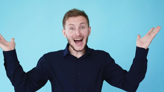 Peekaboo gesture. Hide and seek game. Boomerang motion. Playful peeking happy man closing face with hands isolated on blue background GIF loop animation video.