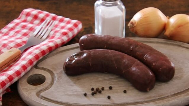 raw black pudding on wooden board