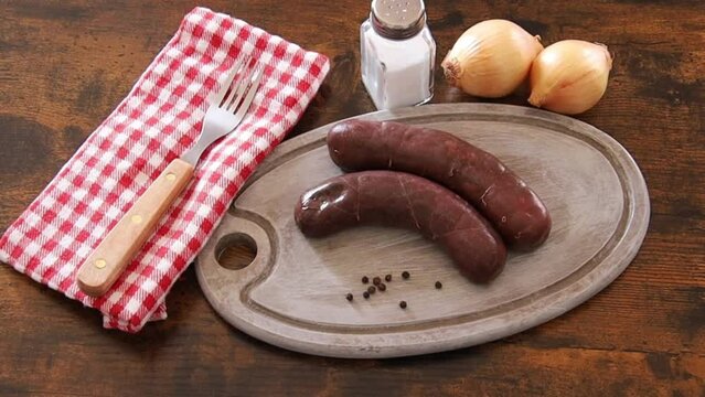 raw black pudding on wooden board