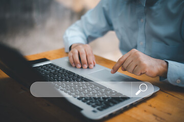 Search technology, search engine optimization,man's hand using laptop computer keyboard to search information,using search engine bar function on your website.People who work in cafes