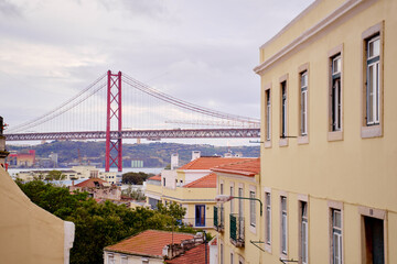 Roof top view on suspension 25 April bridge bridge over the Tagus river in Lisbon, Portugal.