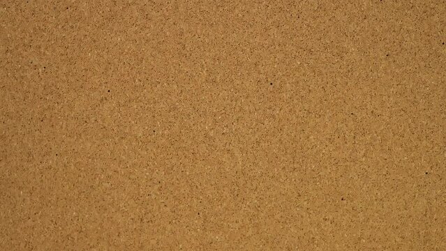 bye bye Stick the sticker on the cork board. Top view of note board. Wall of records in the office. Leave a reminder at work or at home. Caucasian male hand sticks and unsticks paper.