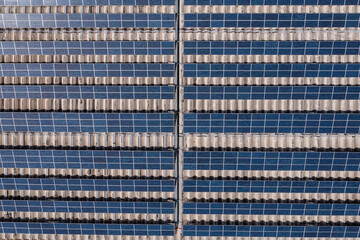 Industrial roof with rows of solar panels, Aerial view.