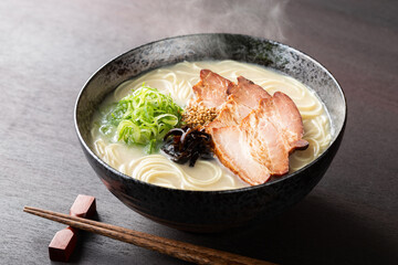 湯気が上がる、シズル感のある豚骨ラーメン