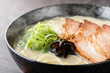 湯気が上がる、シズル感のある豚骨ラーメン