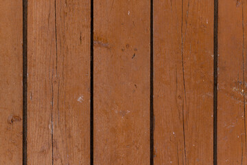 Vertical wooden brown boards. Background with cracked old paint.