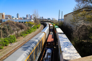 three trains on the railroad tracks with a rusty iron bridge over the trains surrounded by lush...