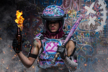 Tattooed woman activist with molotov holding baseball bat