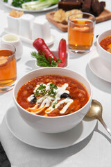 Served dinner table with plate of ukrainian borscht