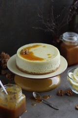 Lemon cheesecake with salted caramel in a plate on a small stand.