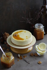 Lemon cheesecake with salted caramel in a plate on a small stand.