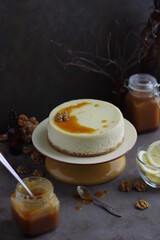 Lemon cheesecake with salted caramel in a plate on a small stand.