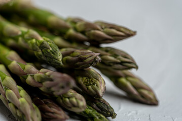 Close-up, beautifully arranged tips of fresh green asparagus in the frame