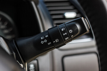 Switch off lights in a car. close-up Car integrated turning indicator with headlight switch toggle.