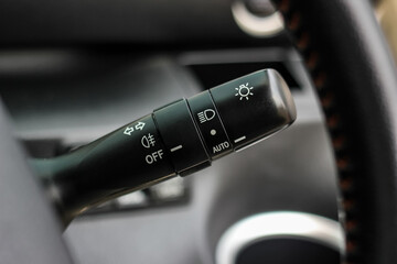 Switch off lights in a car. close-up Car integrated turning indicator with headlight switch toggle.