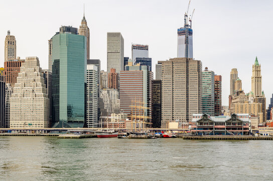 Skyline of Manhattan, New York City, view from waterfront in Brooklyn, One World Trade Center with construction area and crane on top, horizontal