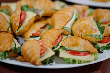 Sandwich with ham, cheese, tomatoes, lettuce and toasted bread.