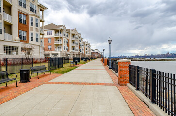 Residential Area at the River in West New York, New Jersey with Hudson river and Fence during...
