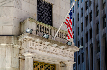 New York Stock Building Exchange golden colored Building Entrance, close-up with American Flag...