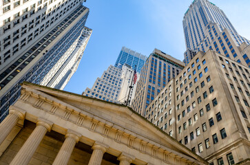 Fototapeta na wymiar Skyscrapers in Financial District Manhattan, New York Stock Exchange, Low angle View, clear sky, horizontal
