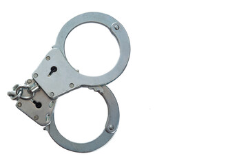 Metal handcuffs on a white isolated background, copy space