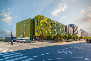 A modern residential building Ørestad plejecenter in bright light green color with windows and balconies in the form of cubes. Copenhagen, Denmark - obrazy, fototapety, plakaty