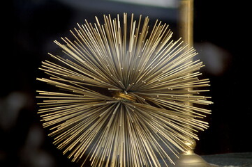 beautiful original ball of gold-colored rods, made by hand