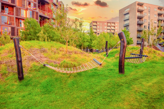 hammocks on wooden poles on green grass stand in the yard near the Tietgen Student Hall Tietgenkollegiet in Copenhagen, Denmark