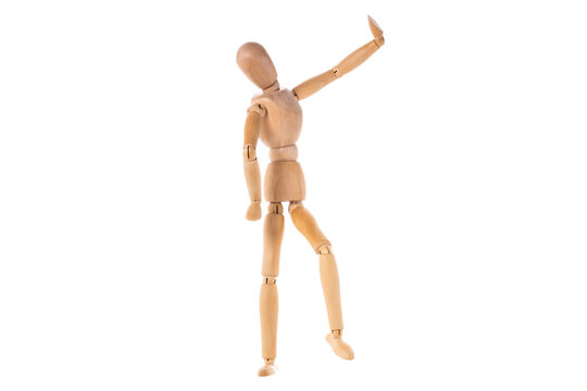 a wooden man stands with his hands up to the top isolated on a white background