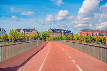 Pedestrian and bicycle bridge across the railways takes towards residential buildings. Copenhagen,...