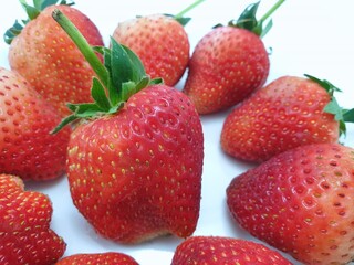 Heap of fresh strawberries isolated on white background, Strawberry as a background ,Selective focus, Fresh fruit ready to eat or making drinks and salads, Healthy concept