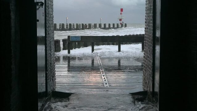 Sea waves on pier during storm called Corrie, Vlissingen, Netherlands