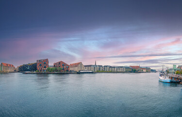 View on small buildings of Christianshavn neighbourhood and water of Copenhagen canal. Copenhagen, Denmark