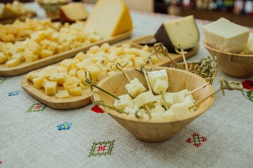 cheese plate in a dish on a Russian tablecloth