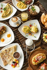 Fototapeta na wymiar Western big gourmet breakfast selection mixed dishes on restaurant table