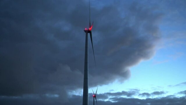 Wind turbine with anti-collision light at dusk, Eemshaven, Netherlands