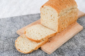 Wheat bread loaf on a white background.	
