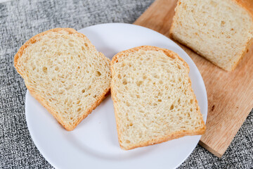 Wheat bread loaf on a white background.	
