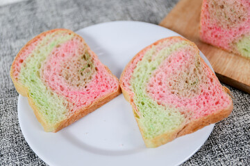 Rainbow bread loaf slice on a white background.	
