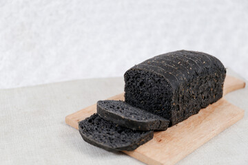 Fototapeta na wymiar Black bread loaf slice on a white background. 