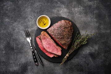 Barbecue Grilled rump cap or brazilian picanha beef meat steak in a wooden tray. Grey background - 496445425