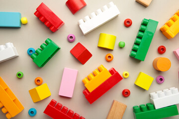 Multicolored blocks of the children's constructor lie on grey background.